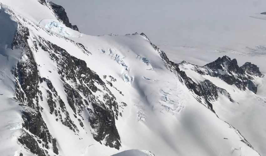Today’s Image of the Day comes from the NASA Earth Observatory and features a look at the gray and brown mountaintops of the southern Antarctic Peninsula.