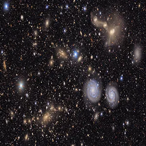 This image captures a small section of NSF–DOE Vera C. Rubin Observatory’s view of the Virgo Cluster, offering a vivid glimpse of the variety in the cosmos. Visible are two prominent spiral galaxies, three merging galaxies, galaxy groups both near and distant, stars within our own Milky Way, and much more. Credit: NSF–DOE Vera C. Rubin Observatory