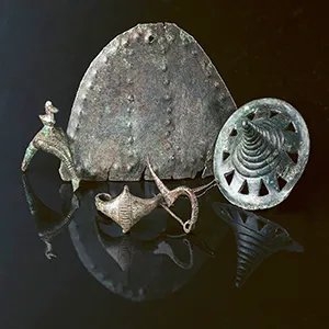 Early Iron Age metal finds from Somló Hill; the diameter of the phalerae with openwork decoration is 45.51mm; the length of the fibulae varies between 34.15 and 55.27mm; the large pendant is 90.1mm long. Credit: László György.
