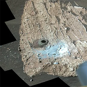 NASA's Perseverance Mars rover used its Mastcam-Z instrument to view a rock nicknamed "Cheyava Falls." A drill hole is visible (far left) where a sample was collected on July 21, 2024. At right is a rock nicknamed "Steamboat Mountain." A circular white abrasion patch can be seen on each rock. Some of these Mars' rock samples could be returned to Earth. Credit: NASA/JPL