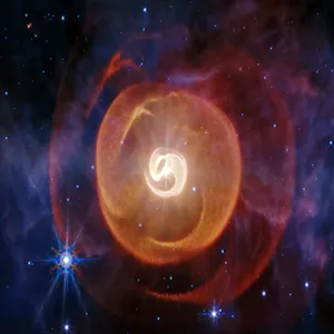 Webb’s mid-infrared image shows four coiled shells of dust around a pair of Wolf-Rayet stars known as Apep for the first time. Previous observations by other telescopes showed only one. Webb’s data also confirmed that there are three stars gravitationally bound to one another. Credit: NASA, ESA, CSA, STScI