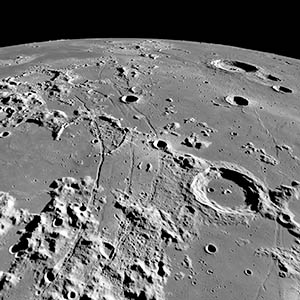 An oblique view of Rimae Hippalus on the Moon, showing the extent of the grabens, which span over 250 kilometers. The image width is roughly 150 kilometers at the bottom, and 500 kilometers on the horizon. The central peak crater Campanus (46-kilometer diameter) is in the right foreground and Bullialdus (61-kilometer diameter) is near the limb (upper right). Credit: NASA/GSFC/Arizona State University