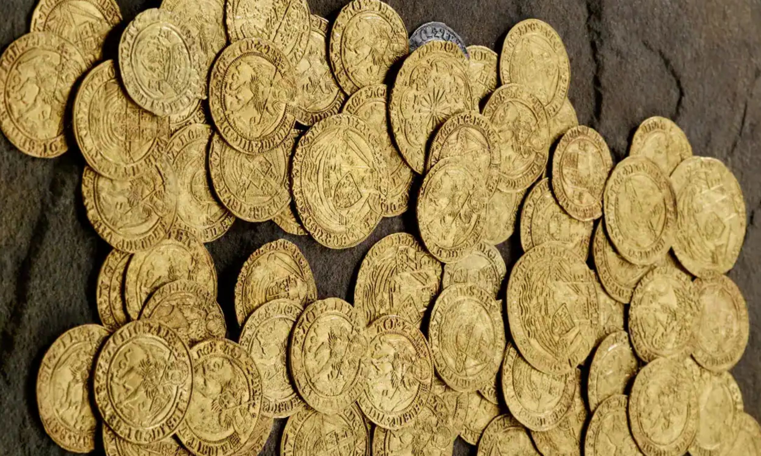 Couple fixing a post in their backyard pulled 70 gold coins out of the mud