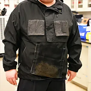 The detachable harvesting units in the jacket are placed in a foldable collector piece and heated to produce the water. Credit: The University of Texas at Austin
