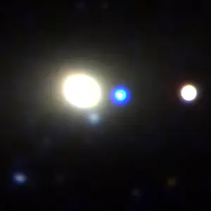 A supermassive black hole revealed itself with a flash of light, shown at the center of this image in blue, as it wandered the edge of a galaxy. Credit: Robert David Stein